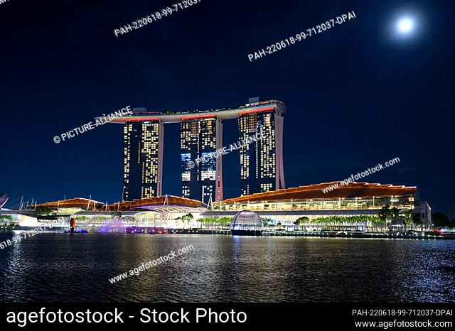 14 June 2022, Singapore, Singapur: Colorfully lit is the Marina Bay Sands Resort in Singapore. Opened in 2010, the hotel also includes a casino, a shopping mall