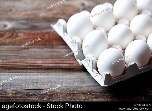 White chicken eggs on old wooden table