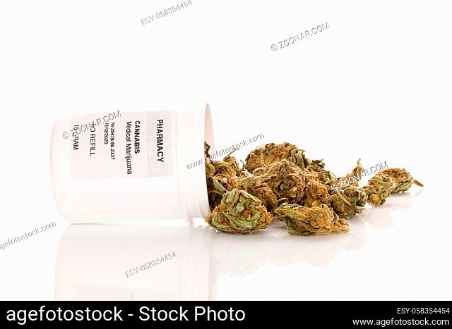Marijuana buds in prescription bottle isolated on white background. Alternative medicine
