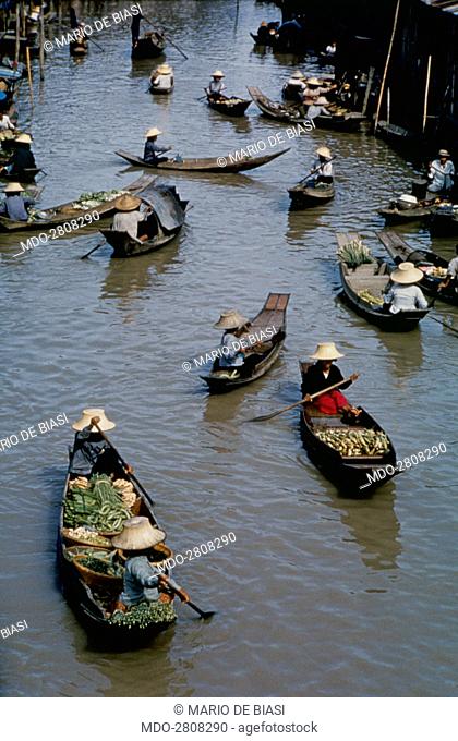 Pirogues full of fruits and greens sailing the river Chao Phraya. Bangkok, 1961