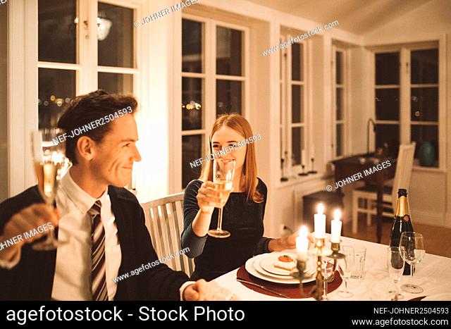 Smiling couple having dinner together