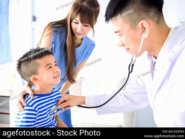 Male pediatrician hold stethoscope exam child boy patient visit doctor with mother