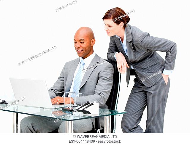 Two business partners working on a laptop