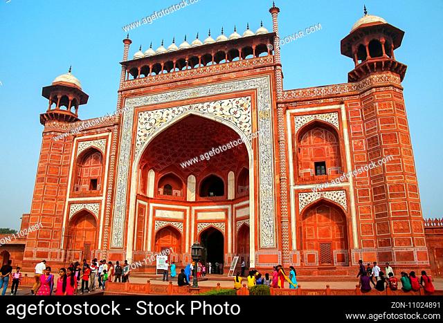 Tourists standing near Darwaza-i-Rauza (Great Gate) in Chowk-i Jilo Khana courtyard, Taj Mahal complex, Agra, India. The gate is the main entrance to the tomb