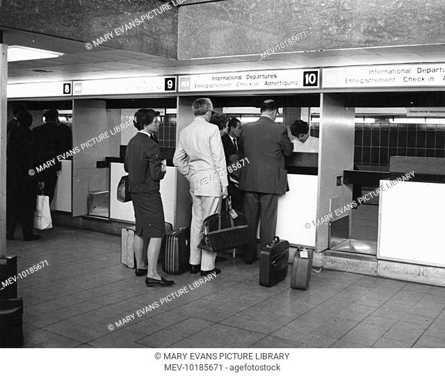 Passengers checking in at the International Departures desk in the Europa Building, London (now London Heathrow) Airport