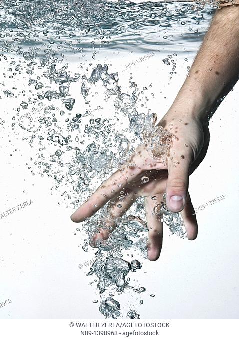 Hand in water on a white background