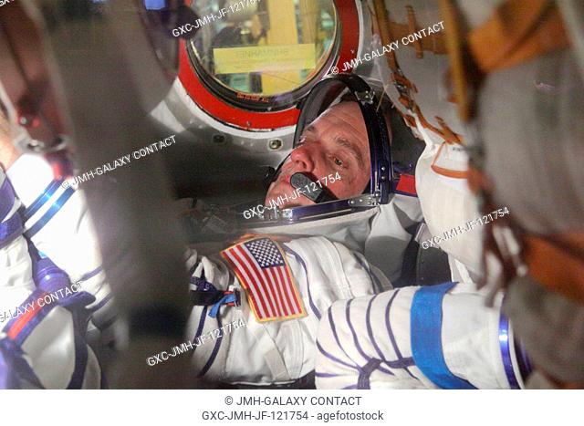 At the Baikonur Cosmodrome in Kazakhstan, NASA Flight Engineer Timothy J. Creamer checks out the systems inside the Soyuz TMA-17 spacecraft during a dress...