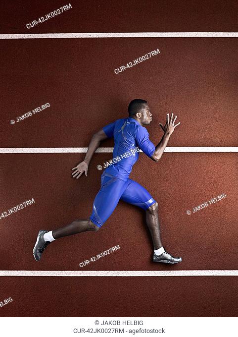 Athlete sprinting/running, lying on track and field stadium