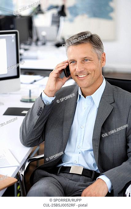 Man in office phoning