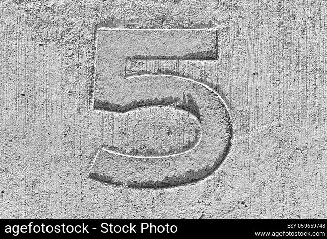 Five number stamped on concrete floor. Cement background
