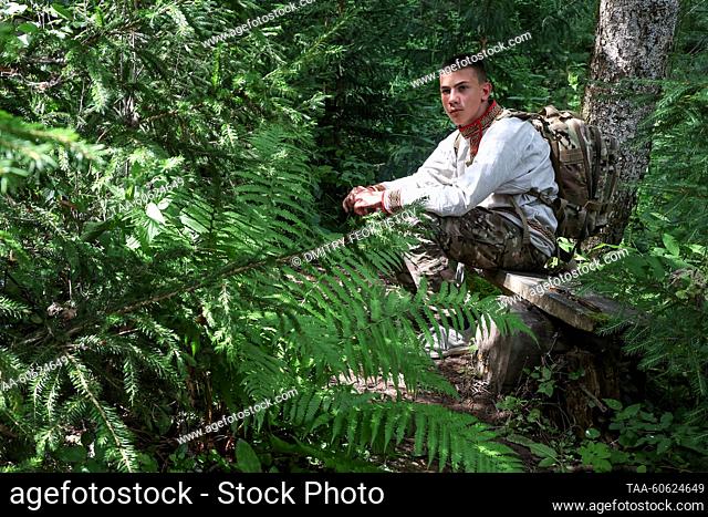 RUSSIA, YAROSLAVL REGION - JULY 23, 2023: A believer sits on a bench during a religious procession in memory of St Irenarchus, recluse of Rostov