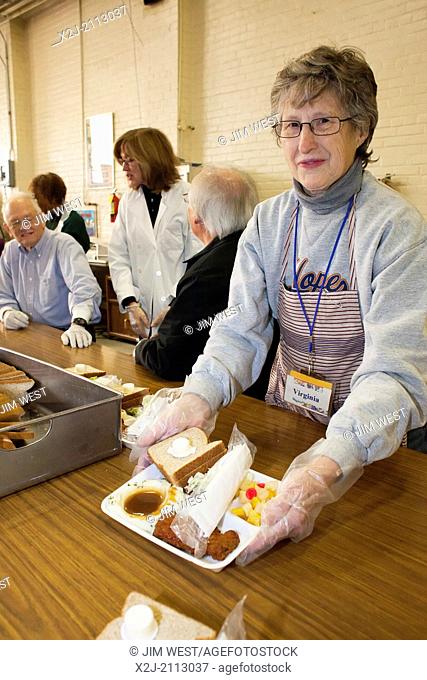 Detroit, Michigan - Volunteers serve a meal to the homeless and low-income individuals at the Open Door Ministry, a project of Fort Street Presbyterian Church