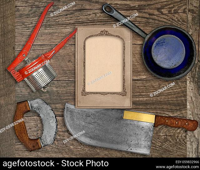 vintage kitchen knife and utensils over wooden board board, blank card for your text