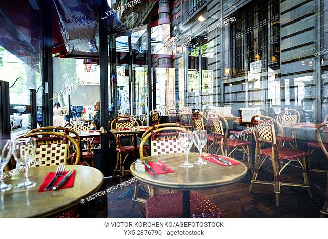 Empty tables at a Parisian cafe