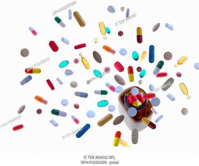 Assortment of pills, tablets and capsules pouring from bottle