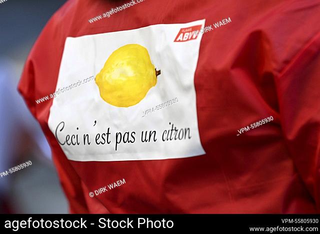 Illustration picture shows a sign that reads 'Ceci n'est pas un citron' on the back of trade union activists, during an action by the Flemish ABVV socialist...