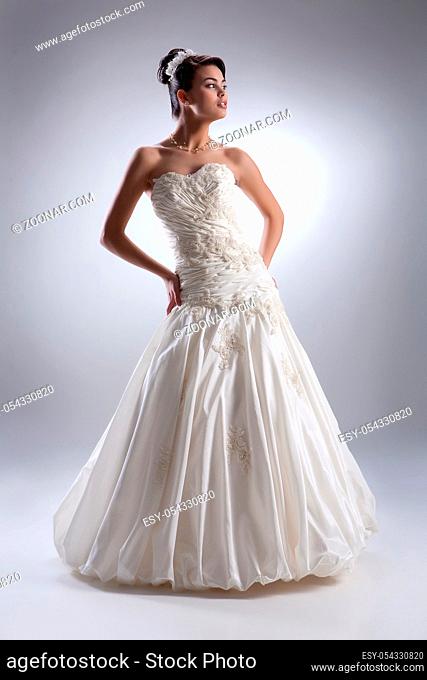 Young beautiful dark-haired woman in a wedding fashionable dress
