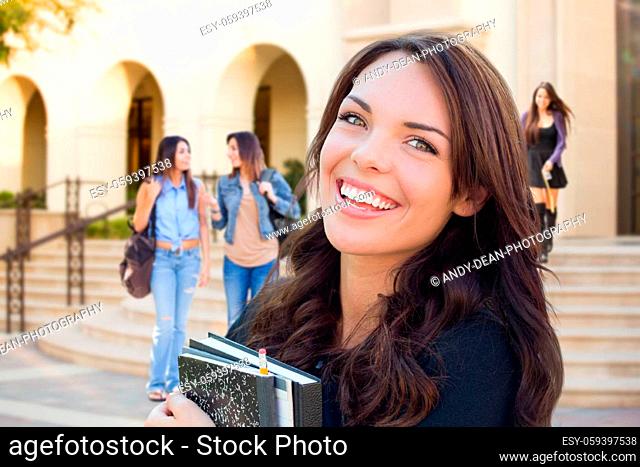 Smiling Mixed Race Young Girl with Books Walking On Campus