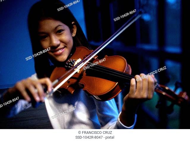 Portrait of a teenage girl playing the violin