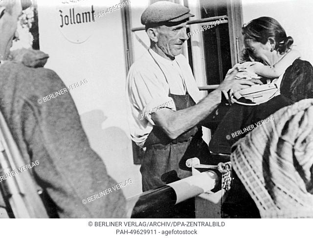 The picture from a Nazi news report shows a Sudeten German family saying goodbye at the barrier at the Austrian-Czech border near Hardegg, Austria