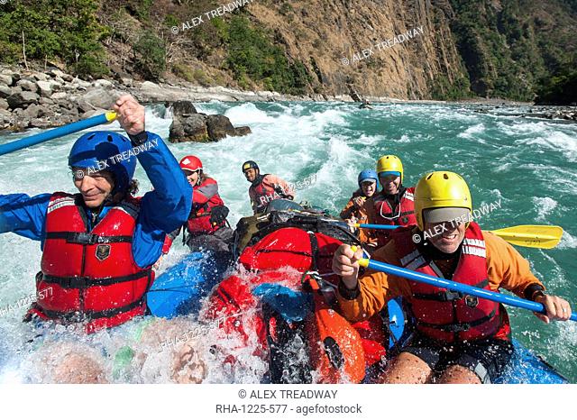 Rafters get splashed as they go through some big rapids on the Karnali River, west Nepal, Asia