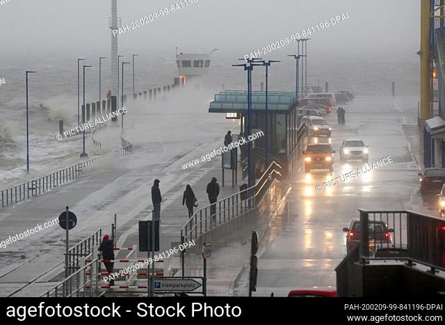 09 February 2020, Schleswig-Holstein, Dagebüll: Meter high the water splashes in a strong storm on the pier of the ferry pier Dagebüll