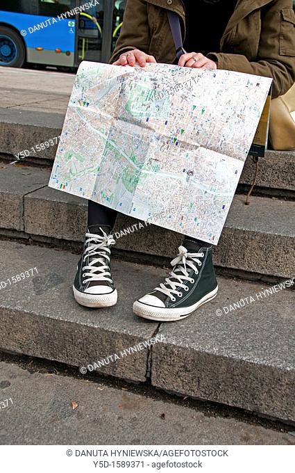 young woman studing the map on the street, actually in Madrid, Spain