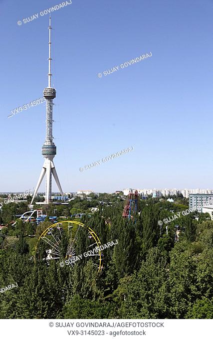 Tashkent, Uzbekistan - May 02, 2017: View of public park, urban buildings and tower in the city