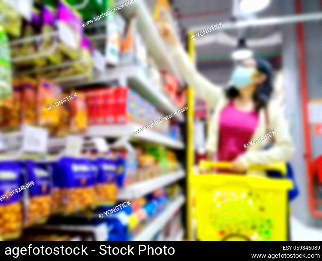 Blurred images of an asian girl shopping in supermarket due to panic shopping because of Corona-Virus, Covid-19. Business and healthcare concept