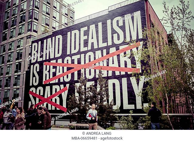 Billboard Blind Idealism is reactionary scary deadly, The High Line is a public park built on a historic freight rail line elevated above the streets on...