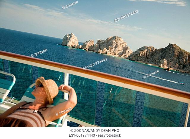 Beautiful Woman Relaxes on a Cruise Ship Deck at Land's End in Cabo San Lucas, Mexico