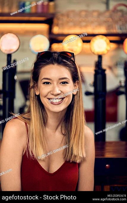 Portrait of a smiling woman in a pub