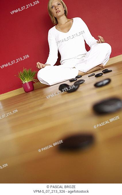 Young woman sitting in the lotus position