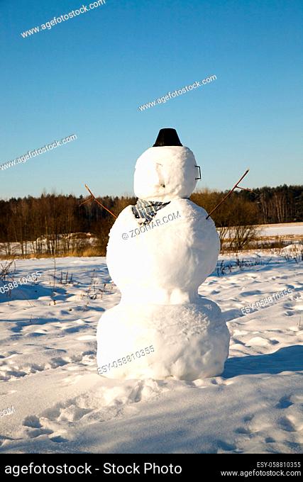 high snowman made by children in ate