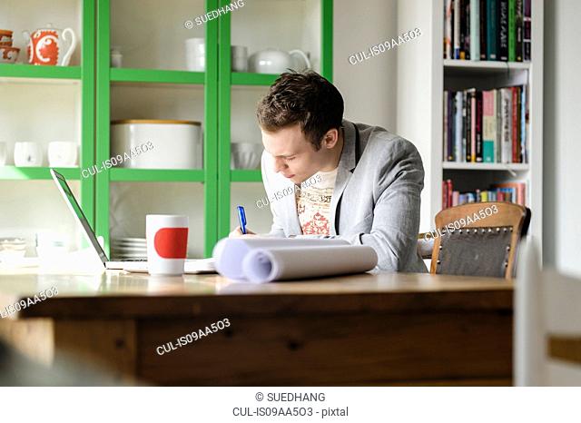 Man writing at desk