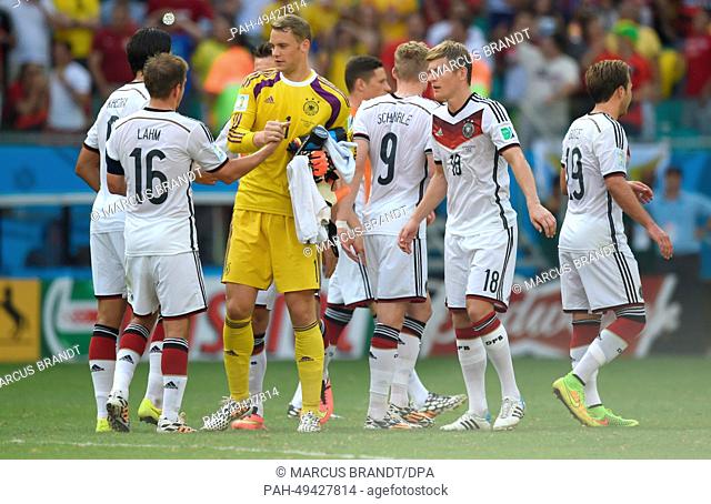 Goalkeeper Manuel Neuer is congratulated by captain Philipp Lahm (L) and other teammate after the FIFA World Cup 2014 group G preliminary round match between...