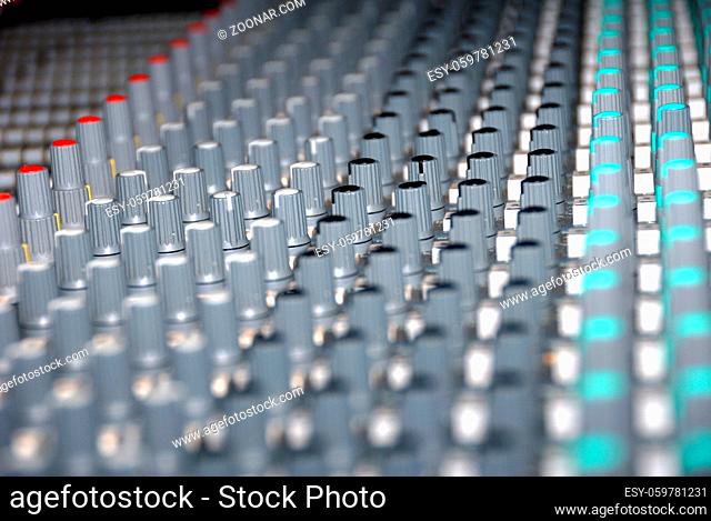 Audio mixing console in a recording studio. Faders and knobs of a sound mixer
