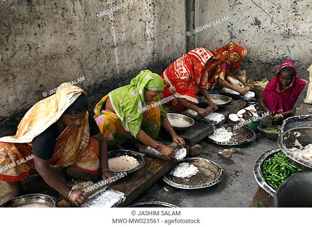 A group of women preparing food for a feast Mezban Persian word meaning ‘host’ stands for community feast, with a simple menu of rice and beef-curry only It’s a...