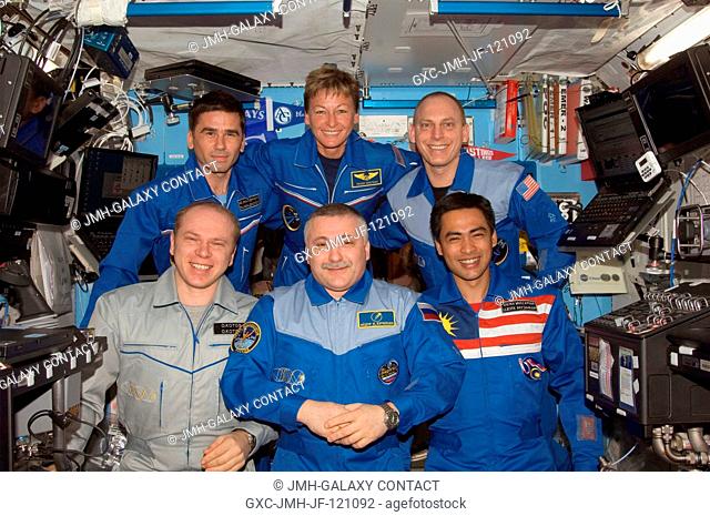 The crewmembers onboard the International Space Station pose for a group photo in the Destiny laboratory of the International Space Station