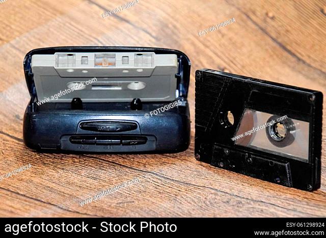 Audio cassette. Retro music medium, compact cassette for tape recorder. Retro audio cassettes next to a portable player to play compact cassettes