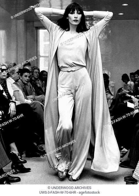 New York, New York: May 23, 1972 Angelica Huston models a Halston Originals jersey evening pants ensemble with a matching full coat