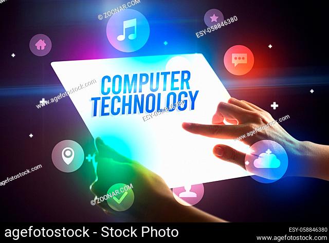 Holding futuristic tablet with COMPUTER TECHNOLOGY inscription, new technology concept