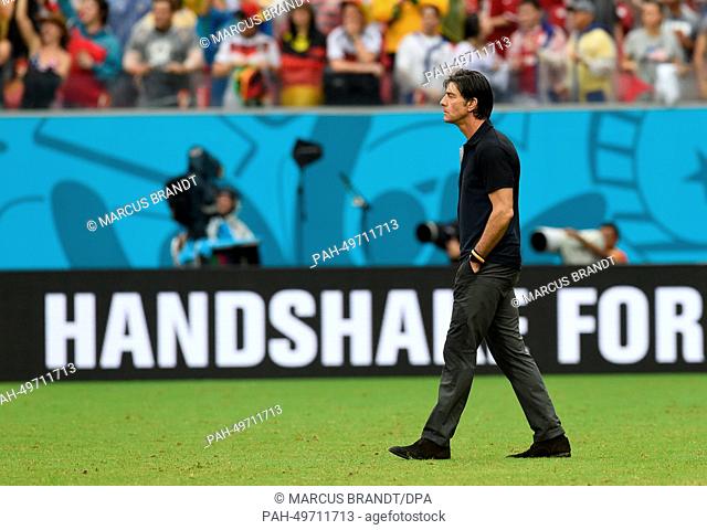 German head coach Joachim Loew walks over the pitch after the FIFA World Cup group G preliminary round match between the USA and Germany at Arena Pernambuco in...