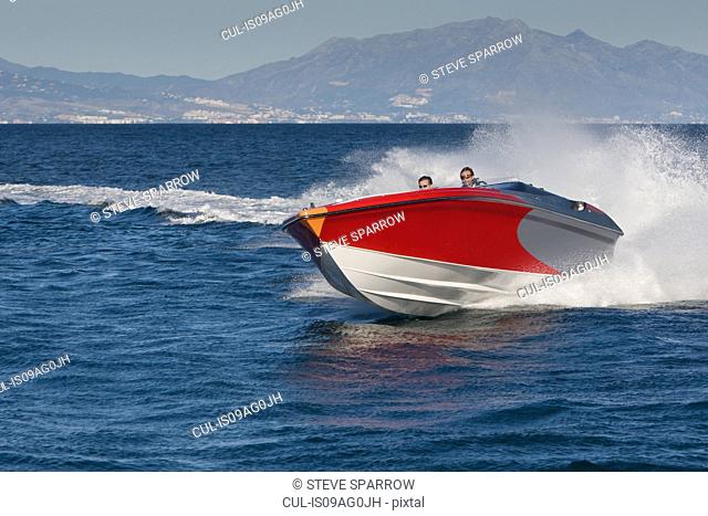 Two adult men having fun in speedboat, Sotogrande, Cadiz, Spain