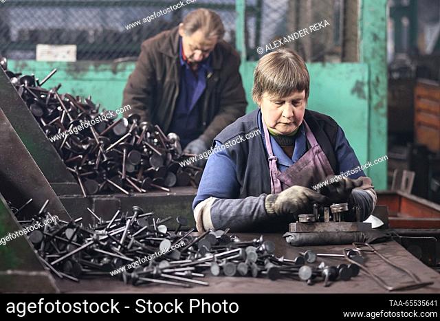 RUSSIA, LUGANSK - DECEMBER 7, 2023: A woman works at AMZ AvtoMotoZapchast, a producer of ICE valves and cooling radiators