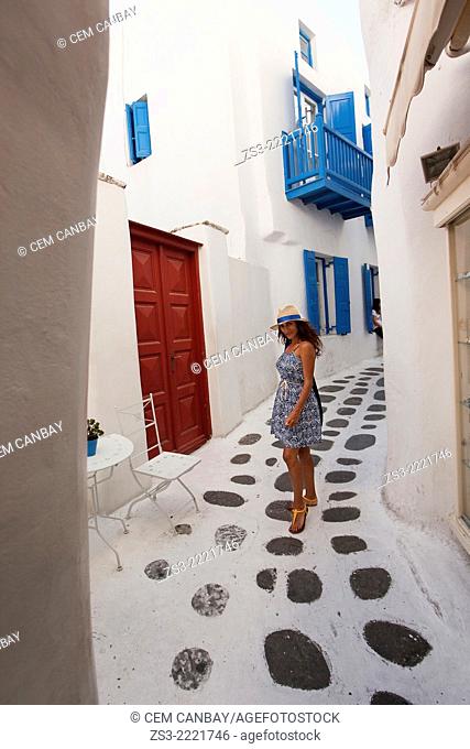 Woman posing in the alleys of town near Little Venice, Mykonos, Cyclades Islands, Greek Islands, Greece, Europe