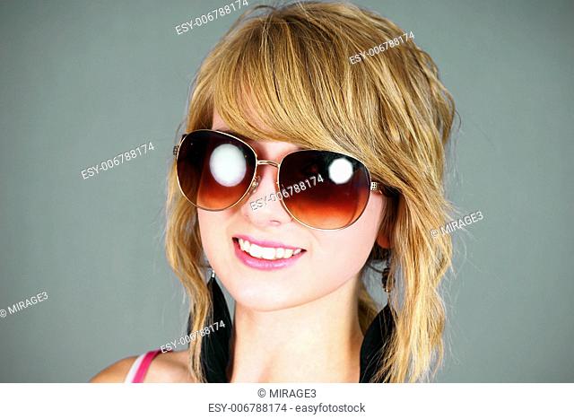Pretty blond young woman with big sunglasses