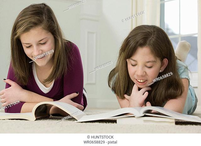 Two teenage girls studying together