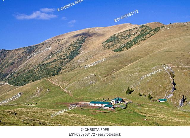 the malga campo alpine hut is idyllically situated at the foot of the altissimo, a popular hiking destination in the monte baldo area