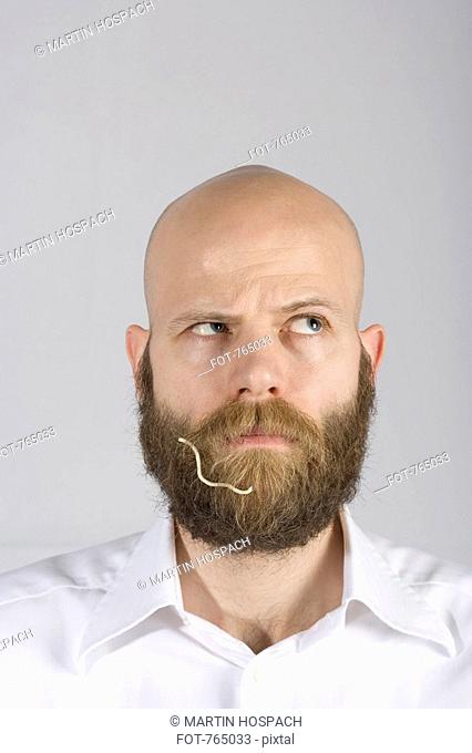 A man with a noodle in his beard
